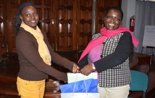 Ms. Hendrina Chalwe Doroba, outgoing Executive Director (right) receives a farewell gift from the Human Resources and Administration Officer Ms. Lilian Nanzala at a farewell party